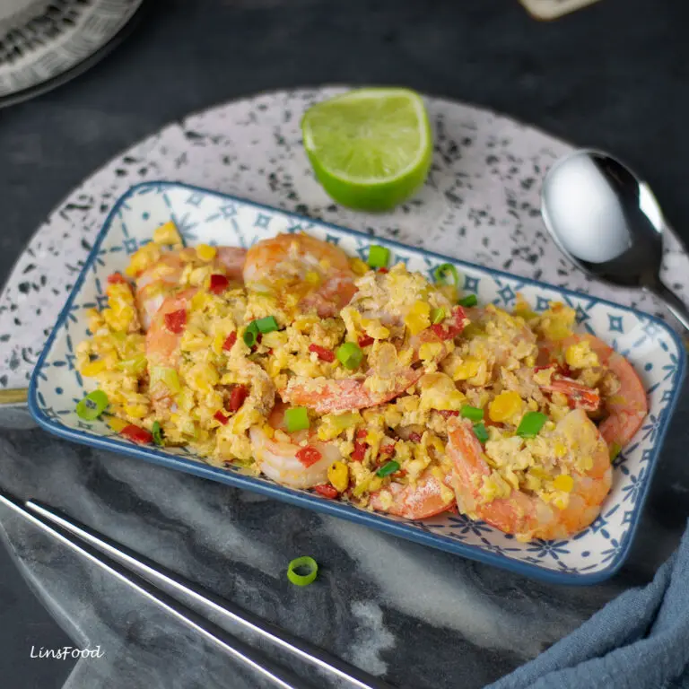 prawns (shrimp) with eggs on a rectangular blue flowery blue plate on round marble board