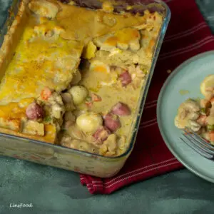 Eurasian Christmas Pie in a rectangular dish with sausages and quail eggs