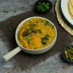dalcha in a grey bowl with a spoon (indian lentils)