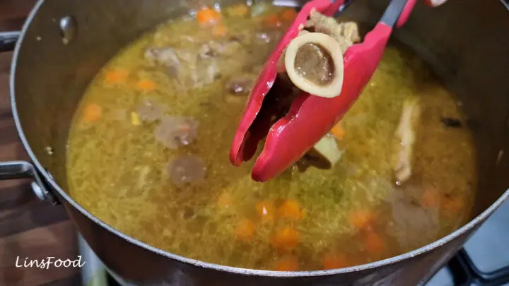 A cooked lamb bone filled with soft marrow, lifted from the sup kambing.