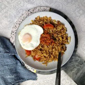 Nasi goreng from Singapore and Malaysia with minced beef, sunny-side-up egg, sambal and tomato slice.