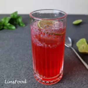 Glass of sirap limau selasih with rose syrup, lime and soaked basil seeds.