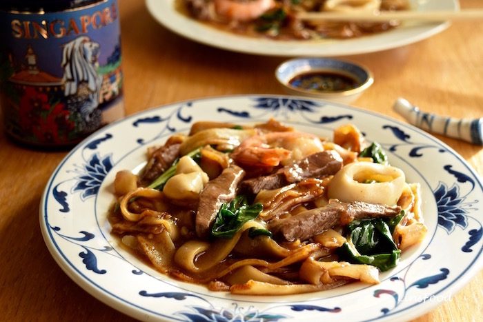 plate of noodles with beef and seafood, singapore beef hor fun