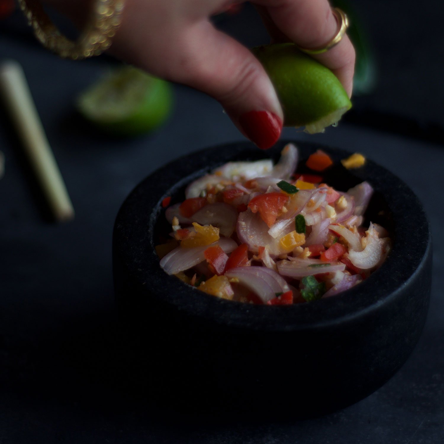 squeezing lime juice on shallot salsa