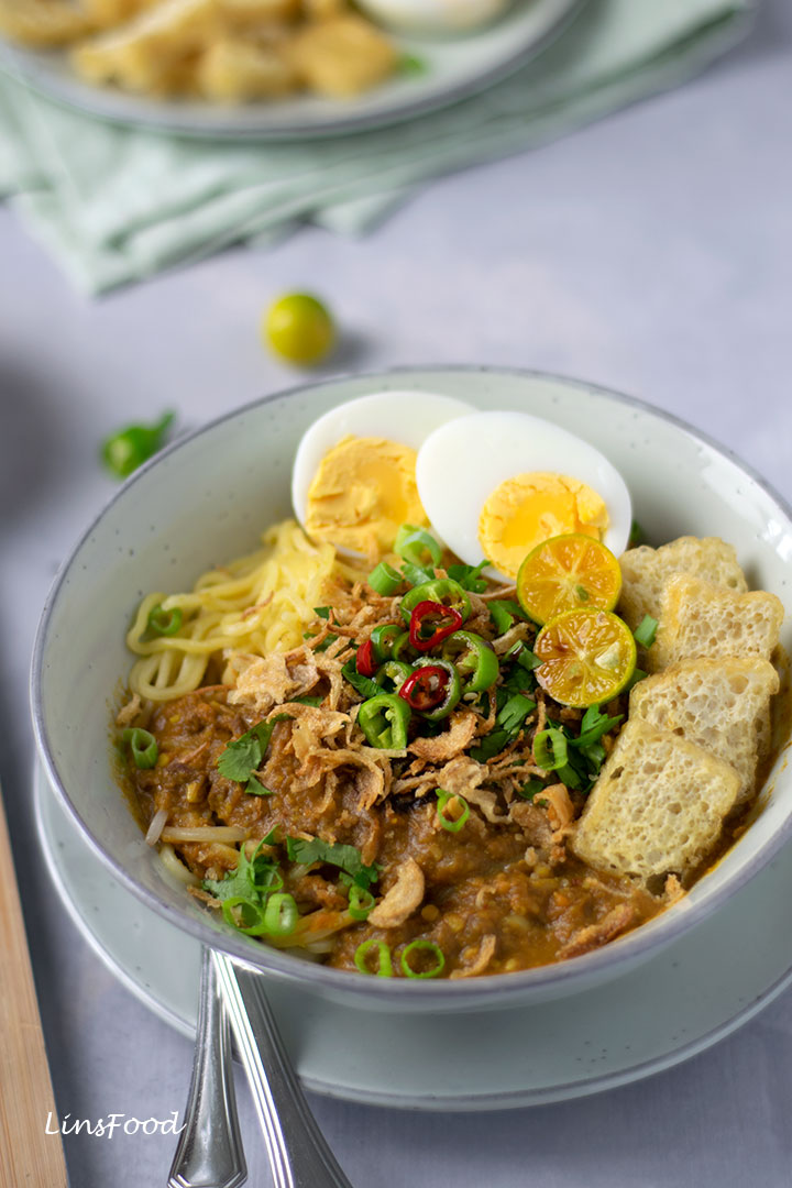 mee rebus (egg noodles) topped with eggs, tofu, chillies limes and gravy