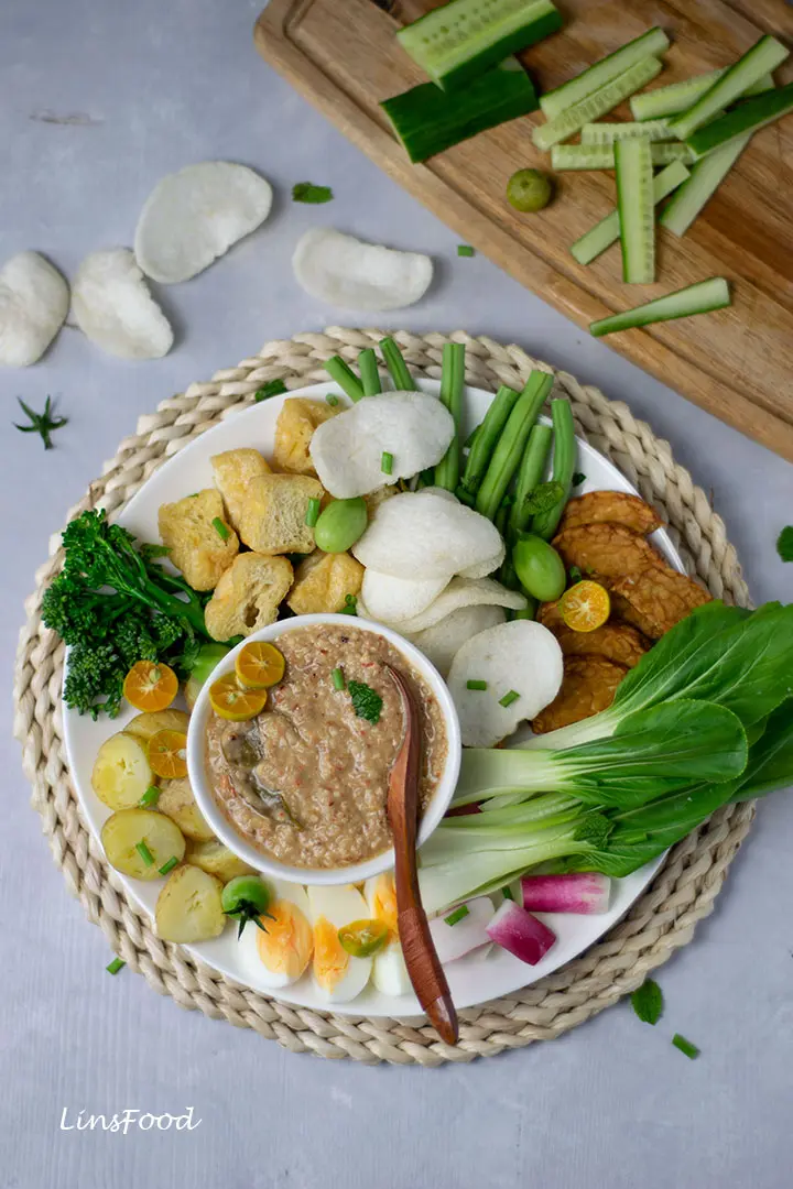 salad with eggs and potatoes with peanut sauce on a white plate