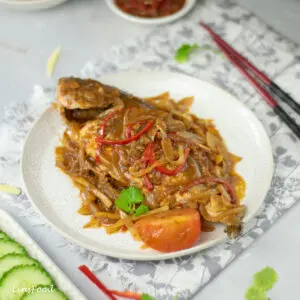 whole fish topped with dark sauce and strips of red chillies and ginger, ikan chuan chuan