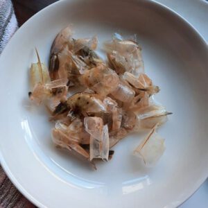 cleaned prawn shells in white bowl