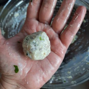 holding homemade prawn ball in palm