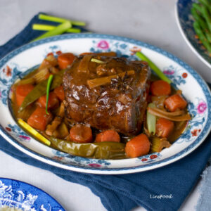 Eurasian pot roast beef with carrots and celery on an oval dish