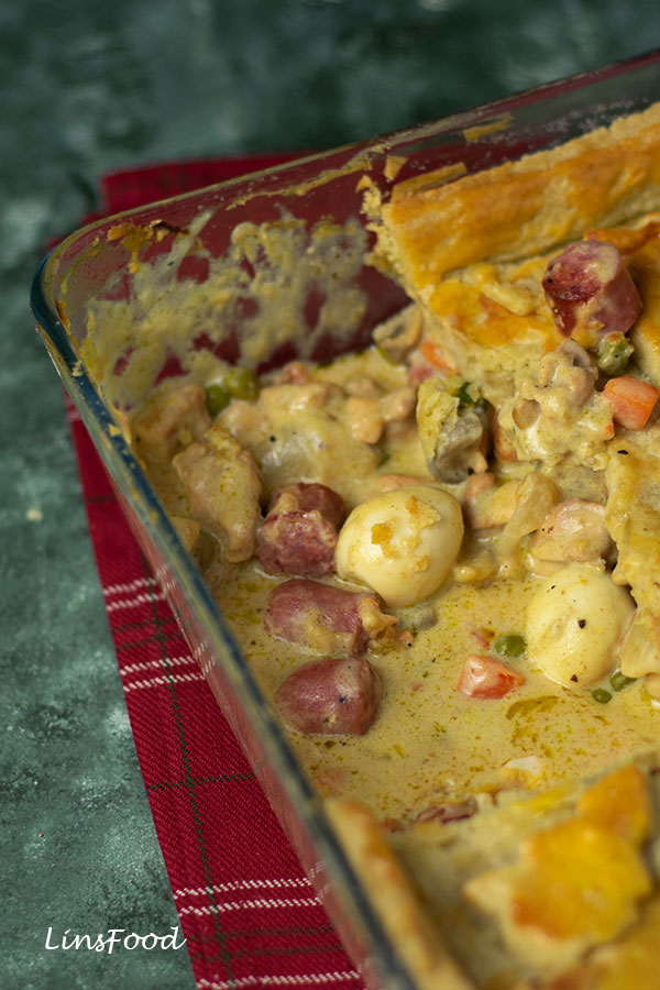 Eurasian Christmas Pie in a rectangular dish with sausages and quail eggs