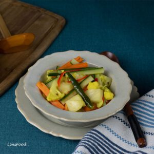acae, a bowl of vegetable pickle with carrots, cucumber and cauliflower