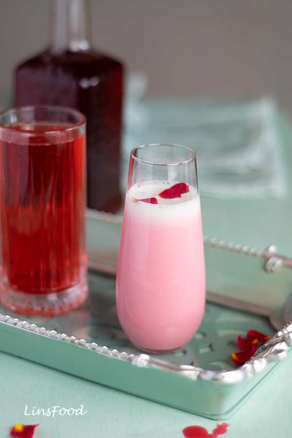 Rose syrup drink and Sirap Bandung (rose milk) served in two glasses on a green tray