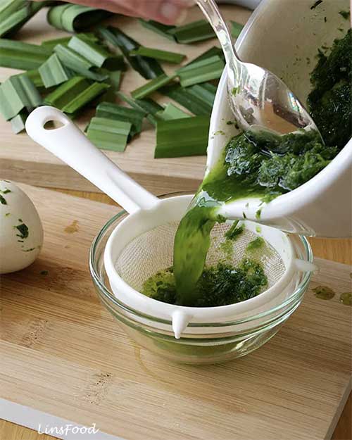 Alt Text
Blended pandan leaves being poured through a sieve to extract pandan juice