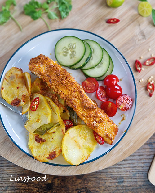 Ikan bakar-inspired salmon traybake with sambal salmon, potatoes, cucumber, tomatoes and chilli.