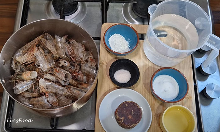 Raw prawn heads and shells with water, palm sugar, white sugar, salt and cornflour for homemade petis udang